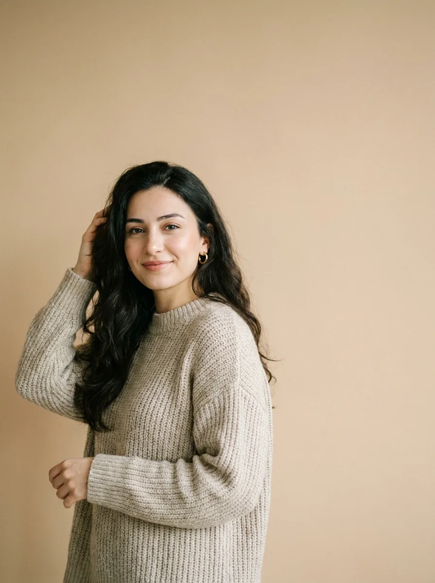 A smiling woman in a knit sweater